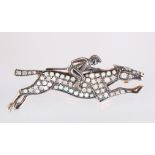 A 9CT GOLD AND SILVER BROOCH set with opals, JOCKEY & HORSE.