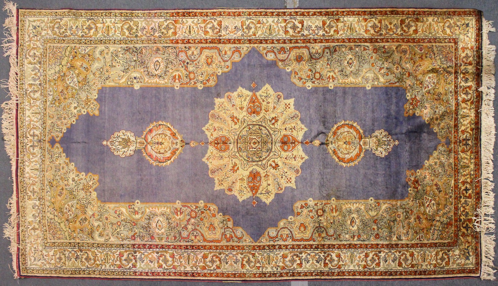 A GOOD KIRMAN PART SILK CARPET, pale blue ground, with stylised floral medallions, within a