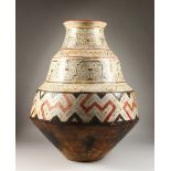 A GOOD PERUVIAN SHIPIBO CULTURE CIRCULAR THREE-TIER POT. 59cms high x 50cms diameter.