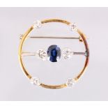 A DIAMOND AND SAPPHIRE CIRCULAR BROOCH.