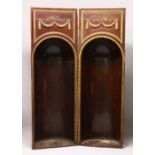 AN UNUSUAL PAIR OF 19TH CENTURY MAHOGANY AND PARCEL GILDED ARCHITECTURAL NICHES, with carved and