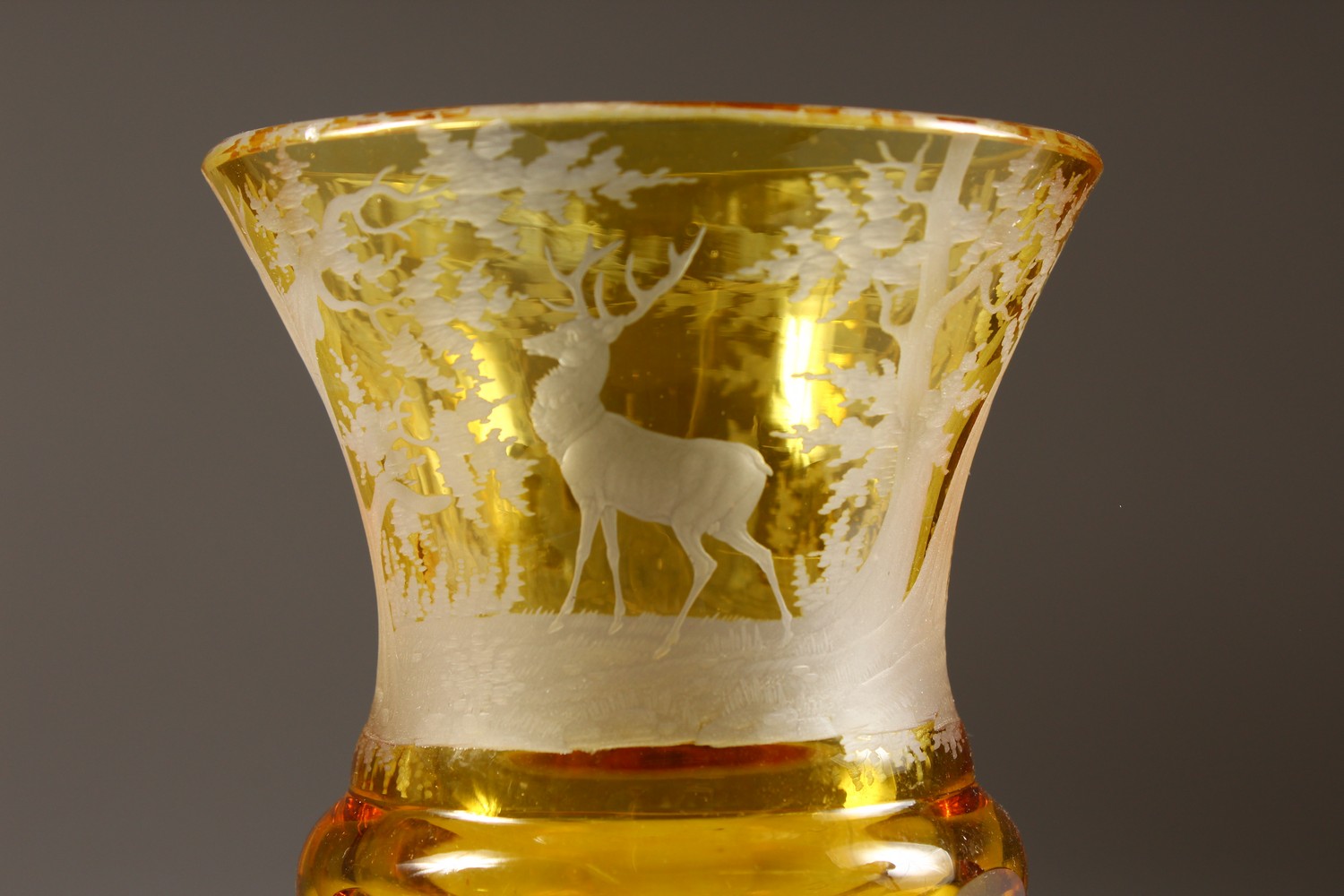 A BOHEMIAN AMBER CUT GOBLET, engraved with deer in a wood. 7ins high. - Image 2 of 6