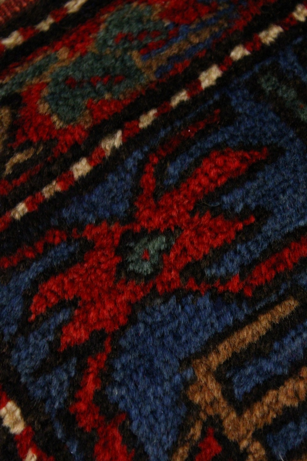 A GOOD CAUCASIAN CARPET, red ground with three large medallions, with stylised decoration, in a - Image 2 of 4
