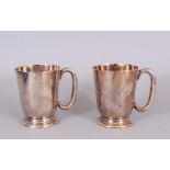 A PAIR OF PLAIN PINT TANKARDS.