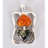 A SILVER AND HEART SHAPED AMBER PENDANT.