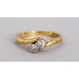 AN 18CT GOLD AND DIAMOND CROSSOVER RING.