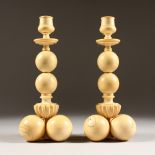 A PAIR OF FRENCH CARVED IVORY "BALL" CANDLESTICKS. 10ins high.