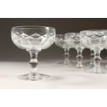 A SET OF TEN CUT GLASS CHAMPAGNE GLASSES.