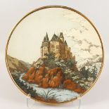 A LARGE CIRCULAR CHARGER with a castle on a rock. Impressed No. 1108. 17ins diameter.