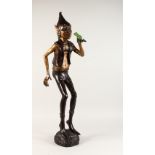 A TWO-COLOUR BRONZE PIXIE holding a frog. 3ft 3ins high.