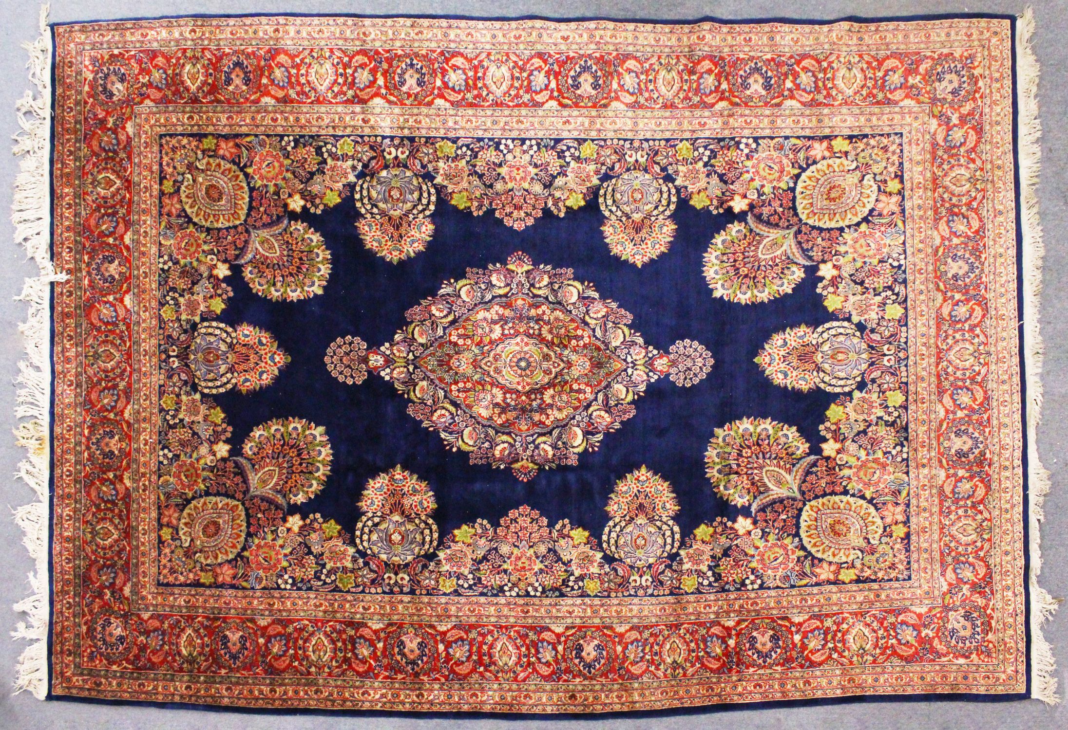 A GOOD LARGE PERSIAN CARPET, deep blue ground, with all-over stylised floral decoration