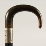 A VICTORIAN RHINO HORN HANDLED WALKING STICK, with hallmarked silver band. 3ft long.