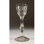 A GEORGIAN WINE GLASS, the bowl engraved with roses, honeysuckle and a bee, with facet stem. 6ins