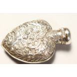 A VICTORIAN HEART SHAPED SILVER CASED SCENT BOTTLE, repousse decoration with cupids, roses and