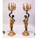 A PAIR OF BLACKAMOOR LAMPS, as female figures holding five electric lights. 3ft 11ins high.