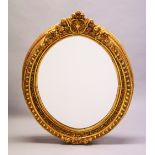 A LARGE GILDED OVAL MIRROR. 3ft 6ins high x 2ft 8ins wide.