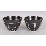 JABU NEME. A PAIR OF BLACK AND CREAM CIRCULAR POTTERY BOWLS. 5.5ins diameter.