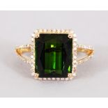 A 14CT YELLOW GOLD AND DIAMOND RING set with an emerald cut green tourmaline approx. 5.19cts.