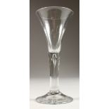 A GEORGIAN WINE GLASS, with teardrop stem and trumpet bowl. 6ins high.