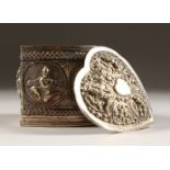 AN INDIAN SILVER HEART SHAPED BOX AND COVER, repousse with scrolls and figures. 6cms high.