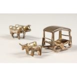 A SMALL SILVER GROUP OF TWO OXEN pulling a cart, and another of TWO OXEN.