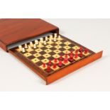 A TRAVELLING CHESS SET, in a mahogany case, complete. 7.5ins.