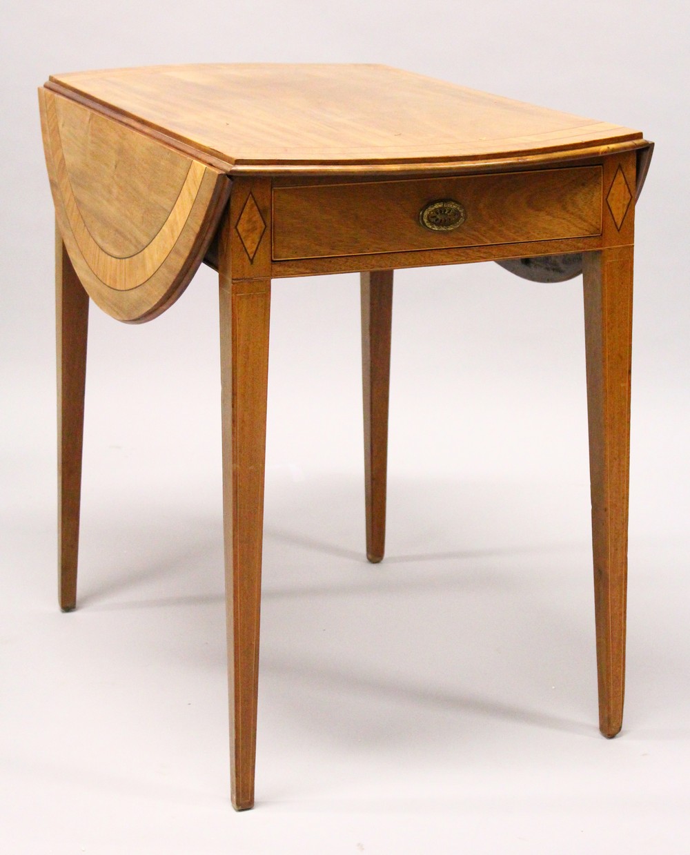 A GEORGE III MAHOGANY AND SATINWOOD BANDED PEMBROKE TABLE, with a drawer to one end, on tapering