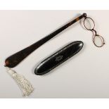 A VICTORIAN BLACK LACQUER SPECTACLE CASE AND LORGNETTE.