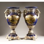 A LARGE PAIR OF SEVRES DESIGN BLUE GROUND TWO HANDLED URN SHAPED VASES with reverse panels of