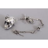 A SILVER SKULL SNUFF BOX on chain.