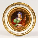 A PARIS CABINET PLATE, painted with a young lady holding a violin. 9.5ins diameter.