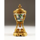 A GOOD SMALL 19TH CENTURY FRENCH ORMOLU AND CHINESE PORCELAIN URN AND COVER, the porcelain painted