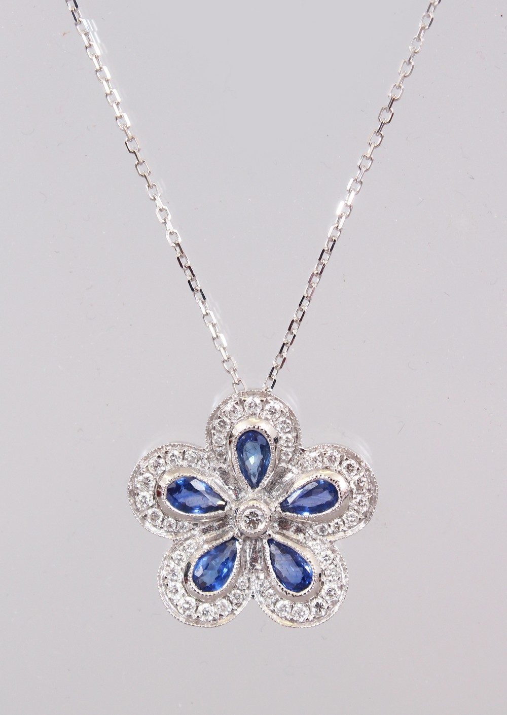 AN 18CT WHITE GOLD FLOWER SHAPED SAPPHIRE AND DIAMOND PENDANT NECKLACE OF 1.5cts. - Image 3 of 3