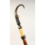 AN ALPINE STICK, with horn and hoof handle, the shaft carved Chamonix. 40ins long.