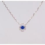 AN 18CT WHITE GOLD SAPPHIRE AND DIAMOND PENDANT NECKLACE on a gold chain, 30 points.