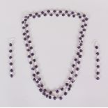 A SILVER AND AMETHYST NECKLACE AND LONG EARRINGS in a box.