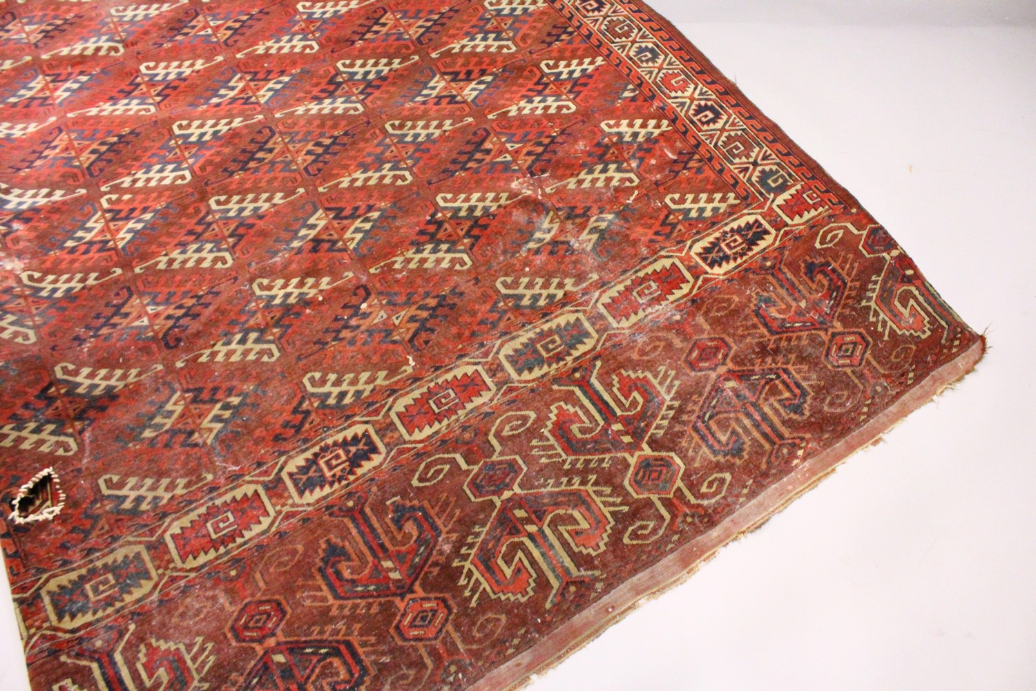 A LARGE BOKHARA CARPET. 10ft x 5ft 9ins.