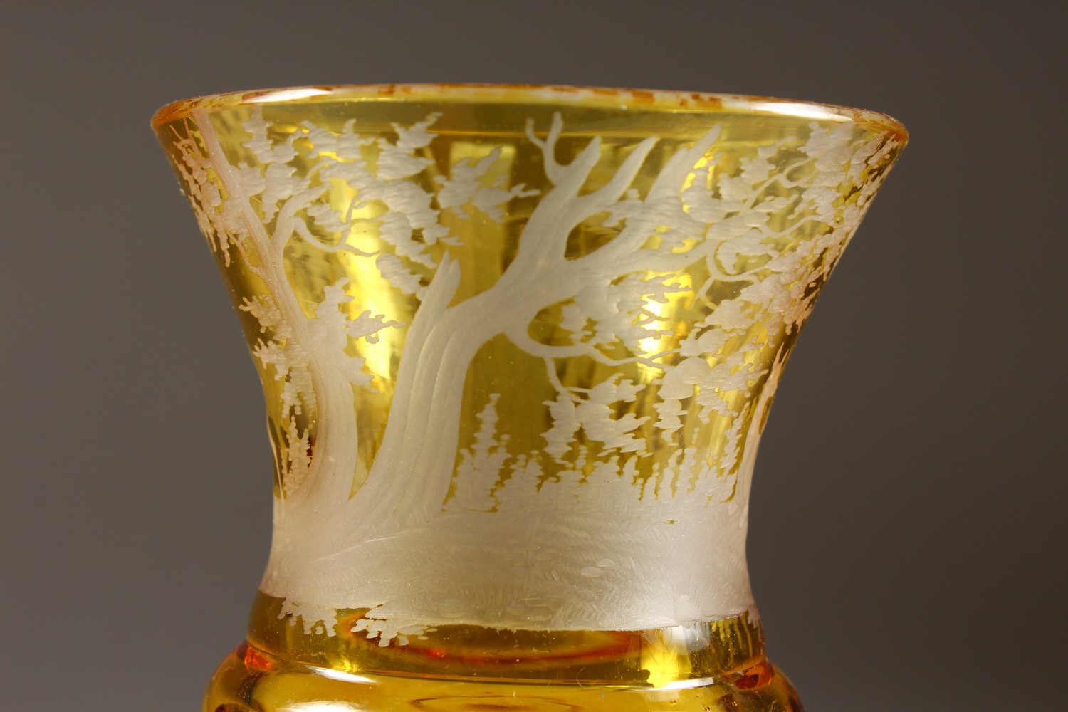 A BOHEMIAN AMBER CUT GOBLET, engraved with deer in a wood. 7ins high. - Image 3 of 6