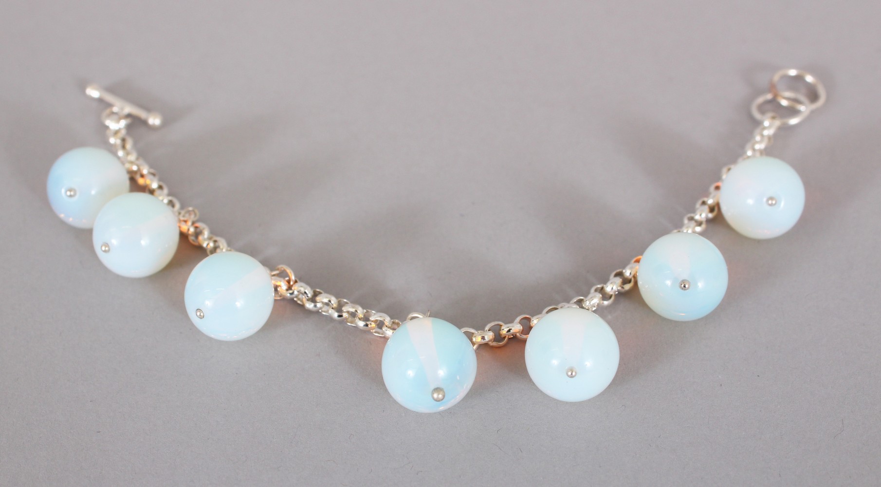 A SILVER AND MOONSTONE BRACELET.