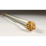 A RARE LONG GLASS MAGNIFYING GLASS ROLLING PIN, with ormolu ends. 18ins long.