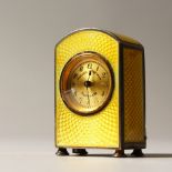 A TINY SILVER AND YELLOW ENAMEL CLOCK by MORASCA & ROSSELLO, MONTEVIDEO. 4.5cms high.