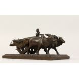 A SMALL INDIAN BRONZE GROUP, OXEN AND CART. 5ins long.