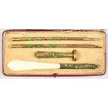 A SILVER AND ENAMEL PEN SET, in a fitted case, comprising seal, knife, pencil and pen.