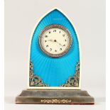 A GOLD FABERGE STYLE BLUE ENAMEL AND SILVER CLOCK, on a stepped base. 12cms high.