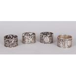 FOUR CHINESE SILVER PIERCED SERVIETTE RINGS.