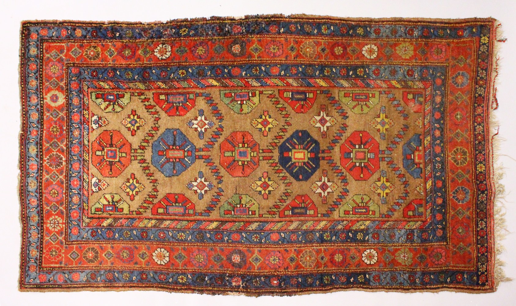 A CAUCASIAN RUG, with six central motifs. 6ft 10ins x 4ft 3ins.