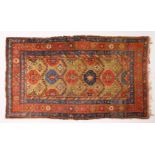 A CAUCASIAN RUG, with six central motifs. 6ft 10ins x 4ft 3ins.