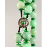 A VERY GOOD DOUBLE ROW OF CARVED JADE BEADS. with diamond clasp.