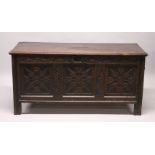 A LARGE 18TH CENTURY OAK DOWER CHEST, with plain rising top, carved frieze and three carved panels