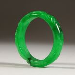 A GOOD CARVED CHINESE JADE BANGLE. 7.5cms diameter.